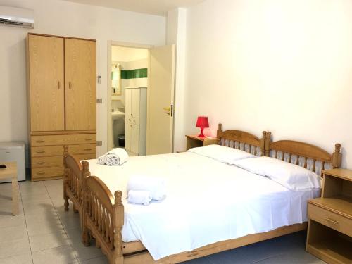 a bedroom with a large bed with white sheets at Guest House - La Sirena Salentina in Patù