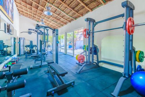 a gym with treadmills and machines in a room at Hotel Paradise Suites in Isla Mujeres