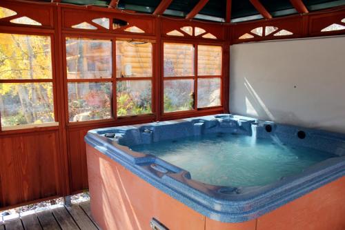 a large hot tub in a room with windows at Spirit Lake Lodge in Grand Lake