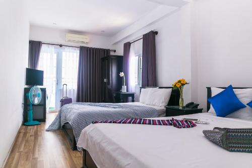 Postel nebo postele na pokoji v ubytování Blue Star Hotel