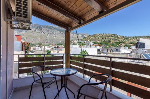 a balcony with two chairs and a table at Zaros in Zaros