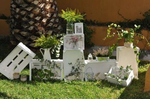 a garden with plants on refrigerators in the grass at Hotel Salobreña Suites in Salobreña