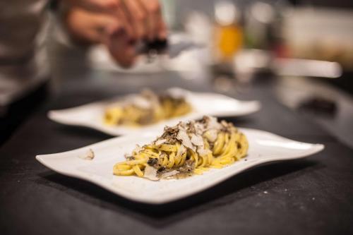 two plates of food sitting on a table at Best Western Hotel Quattrotorri in Perugia