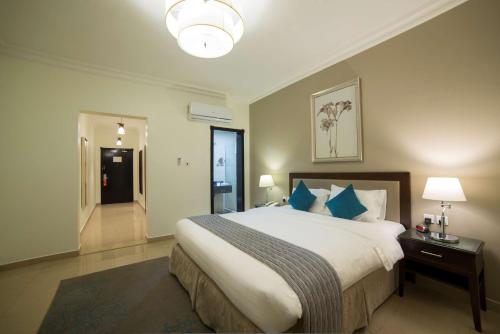Säng eller sängar i ett rum på Tulip Inn Corniche Dammam