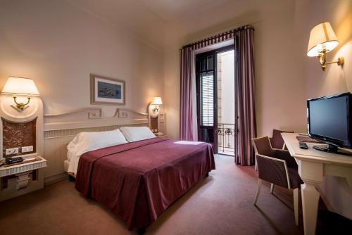 Säng eller sängar i ett rum på Best Western Hotel Stella d'Italia