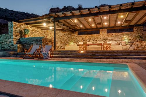 a house with a swimming pool and a patio at Panasea Villa Naxos in Kalando