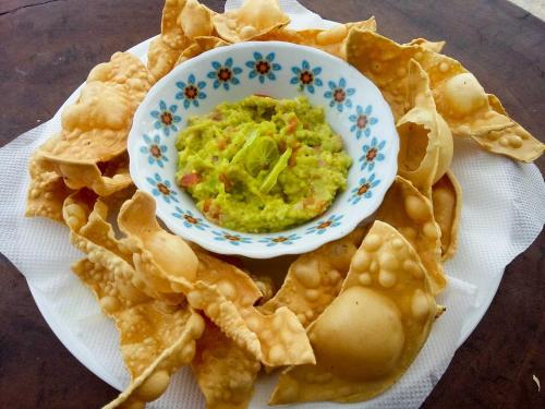 a plate of chips with a bowl of guacamole at Shiva's Beach Cabanas in Tangalle