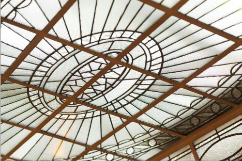 a glass dome ceiling of a building at Hotel Terminus Lyon in Paris