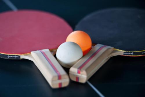 a tennis racket with two balls and an egg in it at Sun 'n Chill, Boutique Apartments & Beach Villa in Melíkia