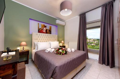 a bedroom with a bed with a large window at Angelo Del'Arte Estate in Corfu