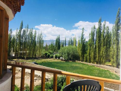 a balcony with a view of a yard with trees at PONYO stays in Leh