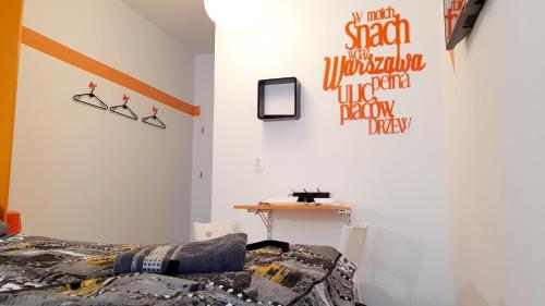 a bedroom with a bed and a desk on the wall at Walk distance to mokotow business park in Warsaw