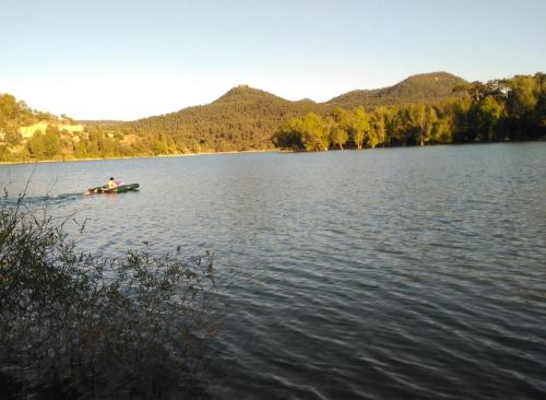 a person in a boat on a lake at El Pretil del Olmo in Cuenca
