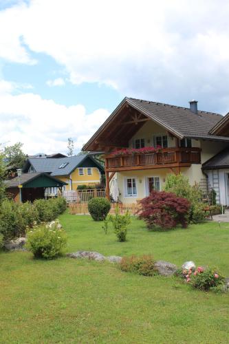 a house with a deck on a yard at Ferienhaus Pepi in Strobl