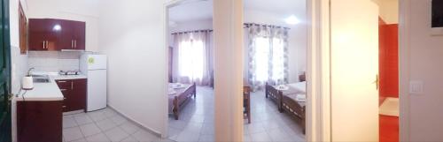 a kitchen with a sink and a kitchen with a mirror at Arianna in Paleokastritsa