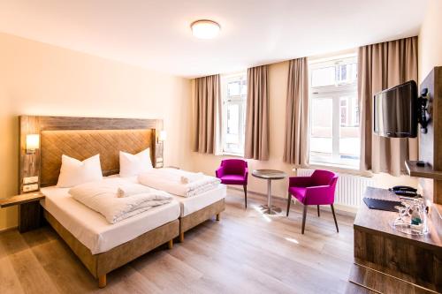 Ένα ή περισσότερα κρεβάτια σε δωμάτιο στο Hotel Am Alten Hafen