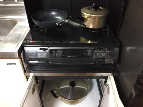 a stove with a pot on top of it in a kitchen at Cool-Residence OTARU in Otaru