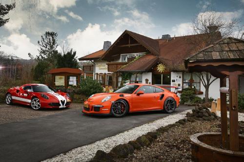 two orange cars parked in front of a house at Landhaus Sonnenhof in Adenau