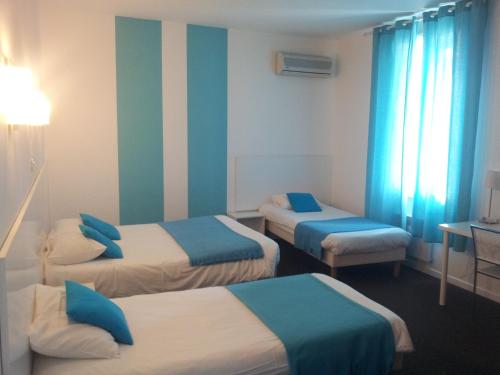 a room with three beds with blue and white at Hôtel Du Midi in Narbonne