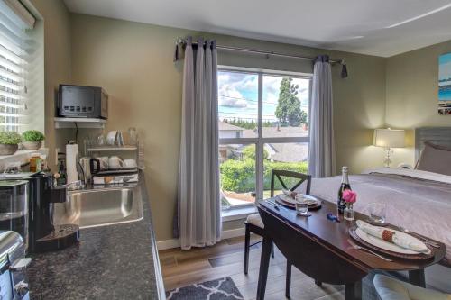 a bedroom with a bed and a table and a window at Blue Angels Room Mercer Island in Mercer Island