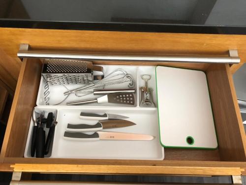 a drawer full of kitchen utensils in a cabinet at Bournemouth Hot Tub & Sauna Holiday Let in Bournemouth