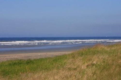 a sandy beach with the ocean in the background at Lighthouse Views in Westport