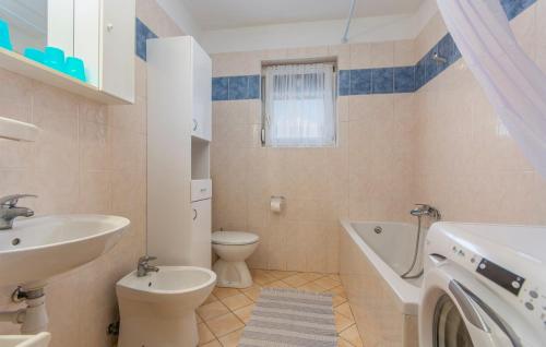 a bathroom with a sink and a toilet and a bath tub at Apartment Leon in Nova Vas