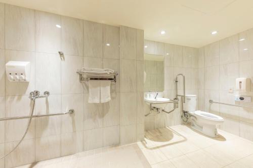 a bathroom with a toilet and a sink at Bitan Hotel in Xindian