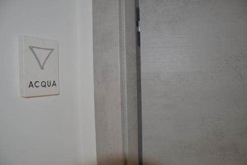 a refrigerator with a sign on the side of it at Quintessenza - Charme Rooms in Vieste