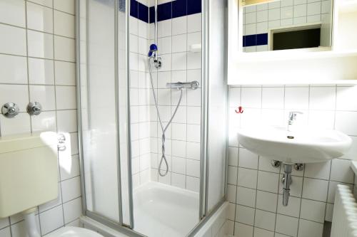 a bathroom with a shower and a sink at Amstel House Hostel in Berlin