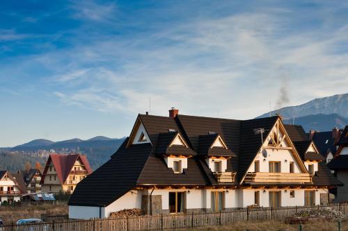 a large house with a black roof at Cubryna in Zakopane