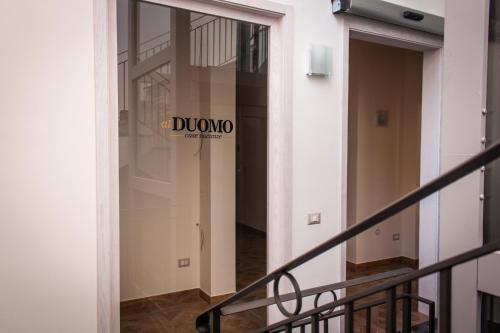 a glass door in a building with a sign on it at Case Vacanze Al Duomo in Licata