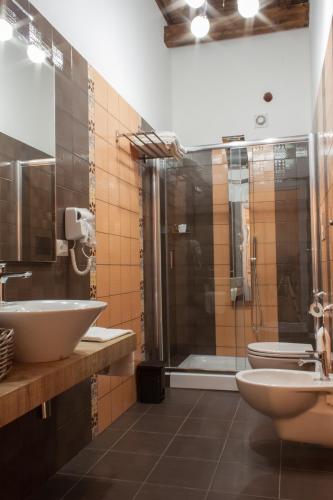 a bathroom with a shower and a sink and a toilet at Case Vacanze Al Duomo in Licata