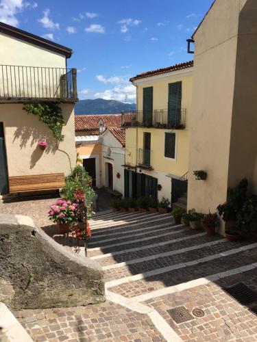 a group of buildings and stairs in a courtyard at B&B Lo Straniero in Rivello