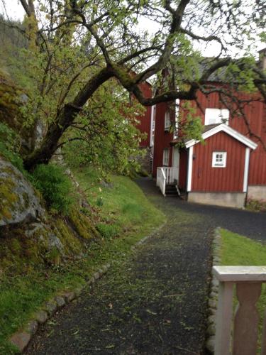 a bench next to a red house with a building at Brunstorpsgård Bränneriet in Huskvarna