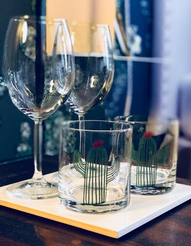 three wine glasses sitting on a tray on a table at Palazzina300 in Treviso