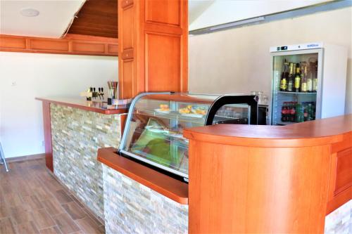 a kitchen with a counter with a drink cooler at Pension Kohler in Deštné v Orlických horách