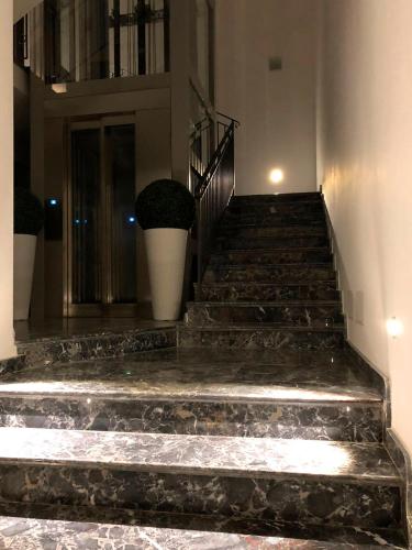 a set of stairs in a building with plants at Case Vacanze Al Duomo in Licata
