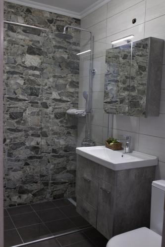 a bathroom with a sink and a glass shower at Blue4Aqua Apartments in Kavala
