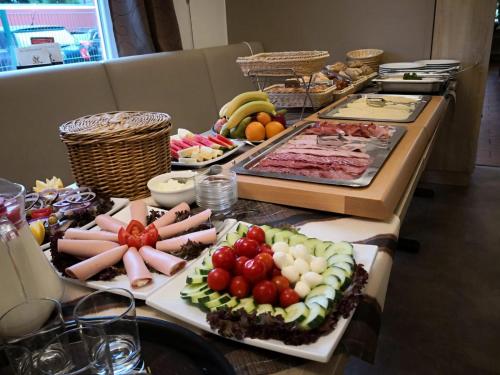 a buffet with many different types of food on a table at Weinhaus Hotel in Norddeich
