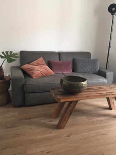 a living room with a couch and a coffee table at appartementen zeespiegel in Zandvoort