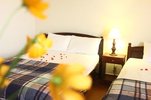 a hotel room with two beds with confetti on the sheets at Minh Kha Hotel in Mui Ne