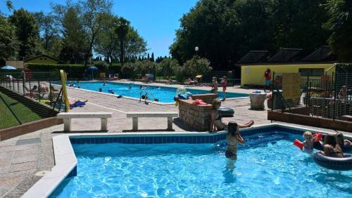 a group of people playing in a swimming pool at Camping Aquileia in Aquiléia