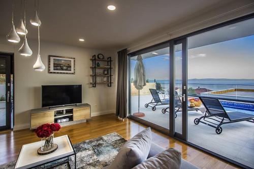 a living room with a view of the ocean at New Mountainside Villa w Pool + Stunning Sea View in Makarska