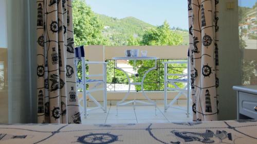 a view of a room with a table and a window at Glafki in Limne