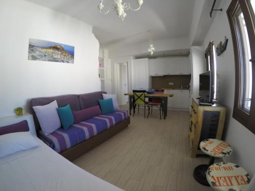 a living room with a couch and a kitchen at Eleni Boutique Apartment in Lindos