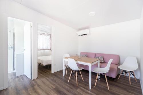 a dining room with a table and chairs at Camping Los Llanos in Denia