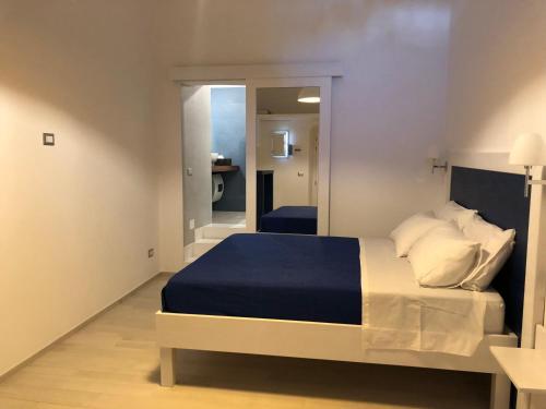 a bedroom with a large bed and a mirror at Monolocale Porticciolo in Peschici