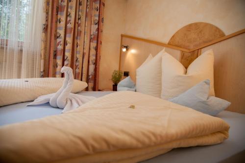 a bedroom with two beds with swans on them at Haus Wulfenia in Neustift im Stubaital