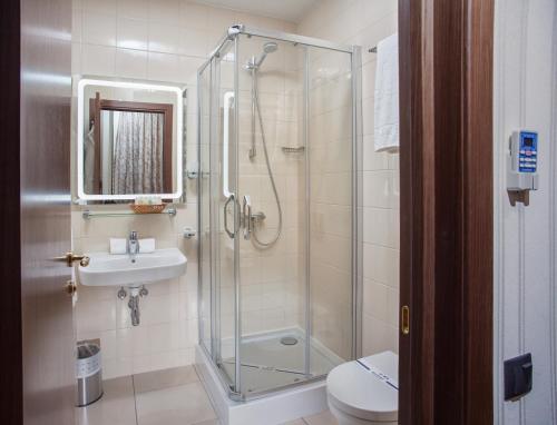 a bathroom with a shower and a toilet and a sink at Hotel Otrada in Odesa